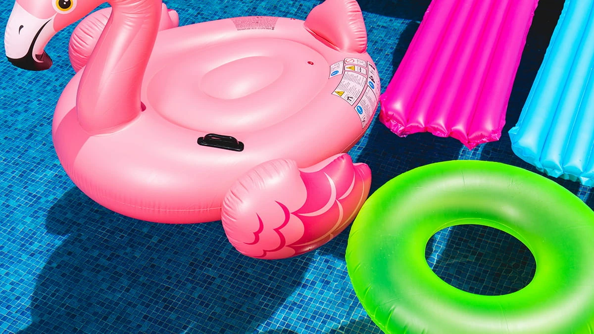 Färgglada poolleksaker i en pool